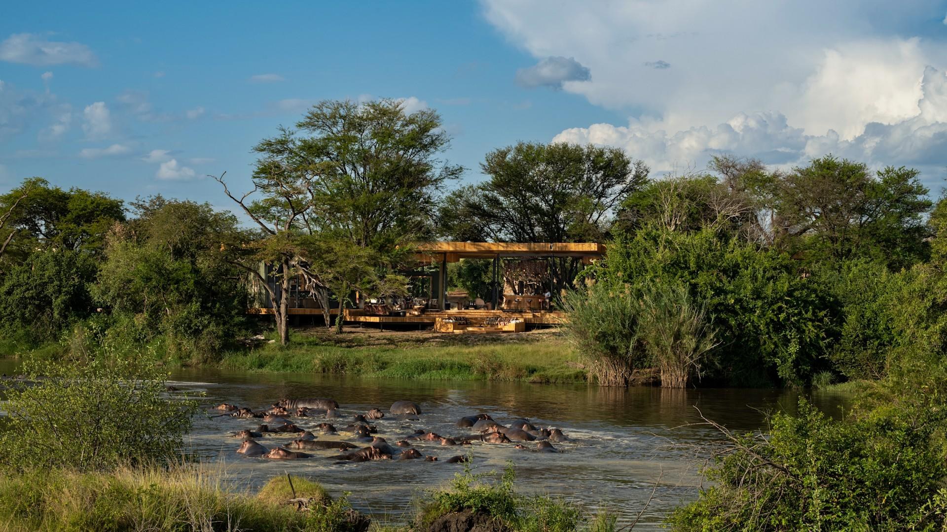 TZ-accommodatie-Grumeti Serengeti River Lodge-Guest Area exterior with hippo pod 2.jpg