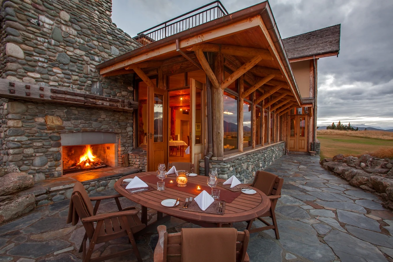 NZ - Fiordland Lodge - Dining by the fire.webp