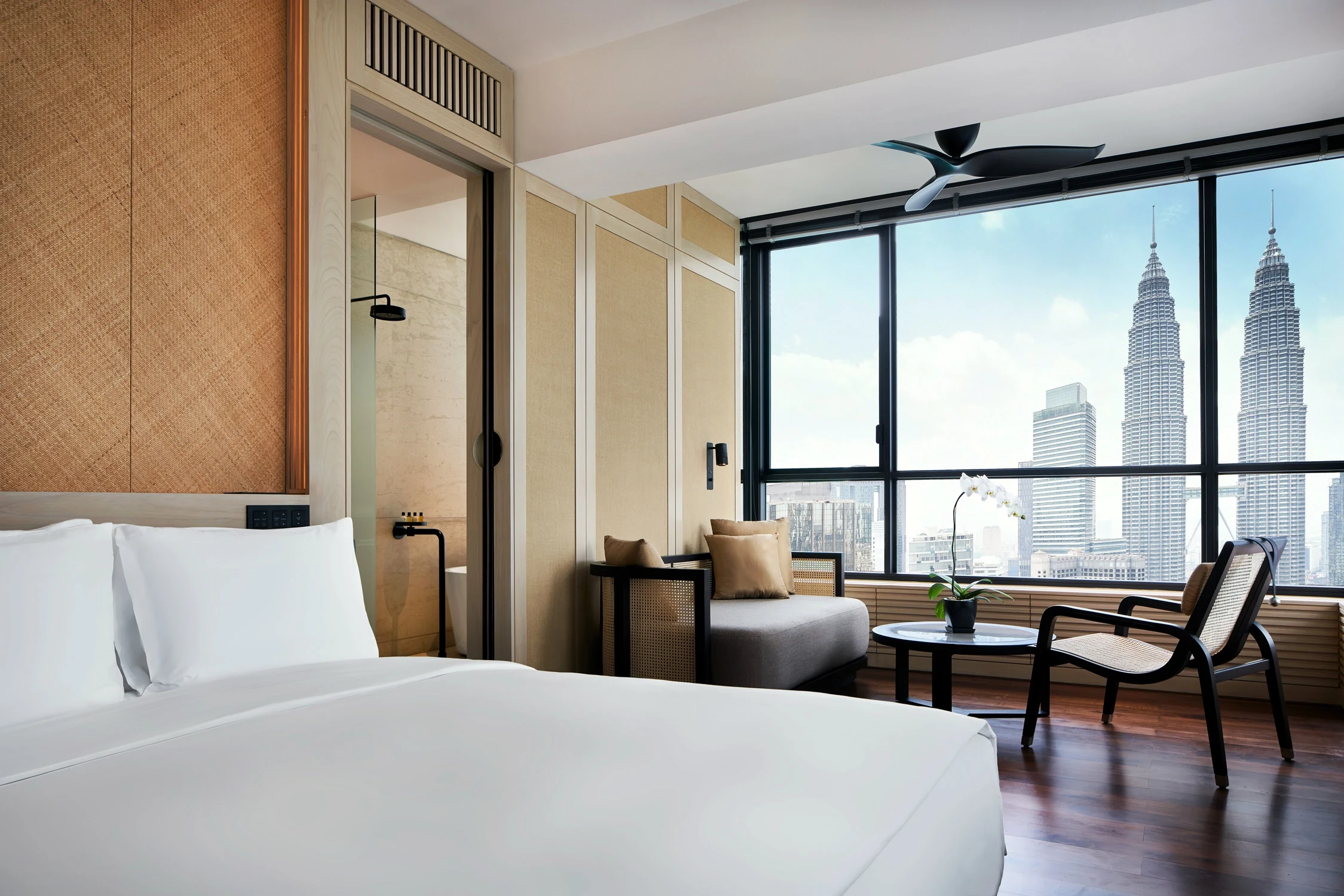 MY-Accommodatie-The RuMa-Deluxe Suite Bedroom with View toward Window.webp