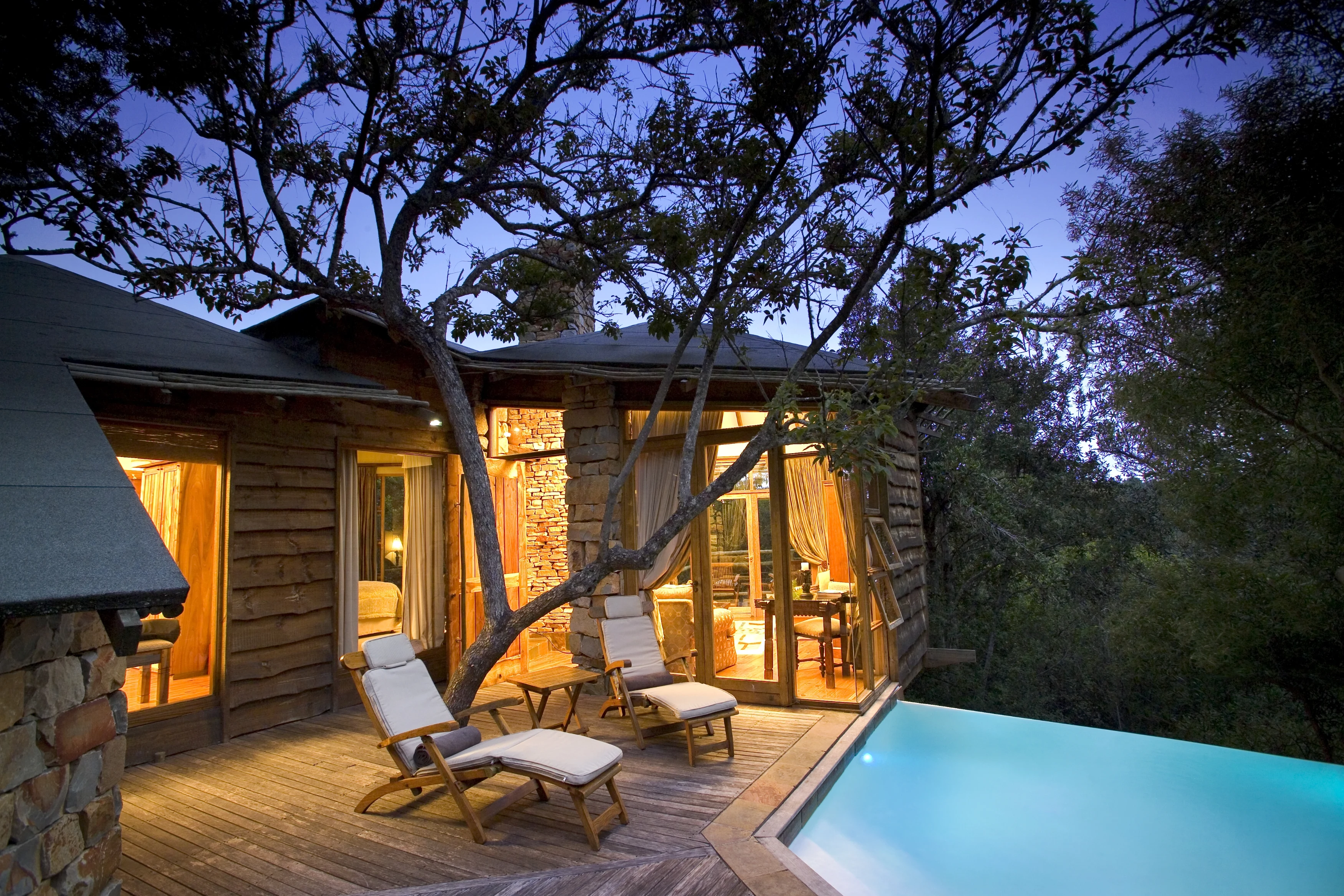 ZA - Tsala Treetop Lodge - Suite Deck & Pool at Dusk .webp
