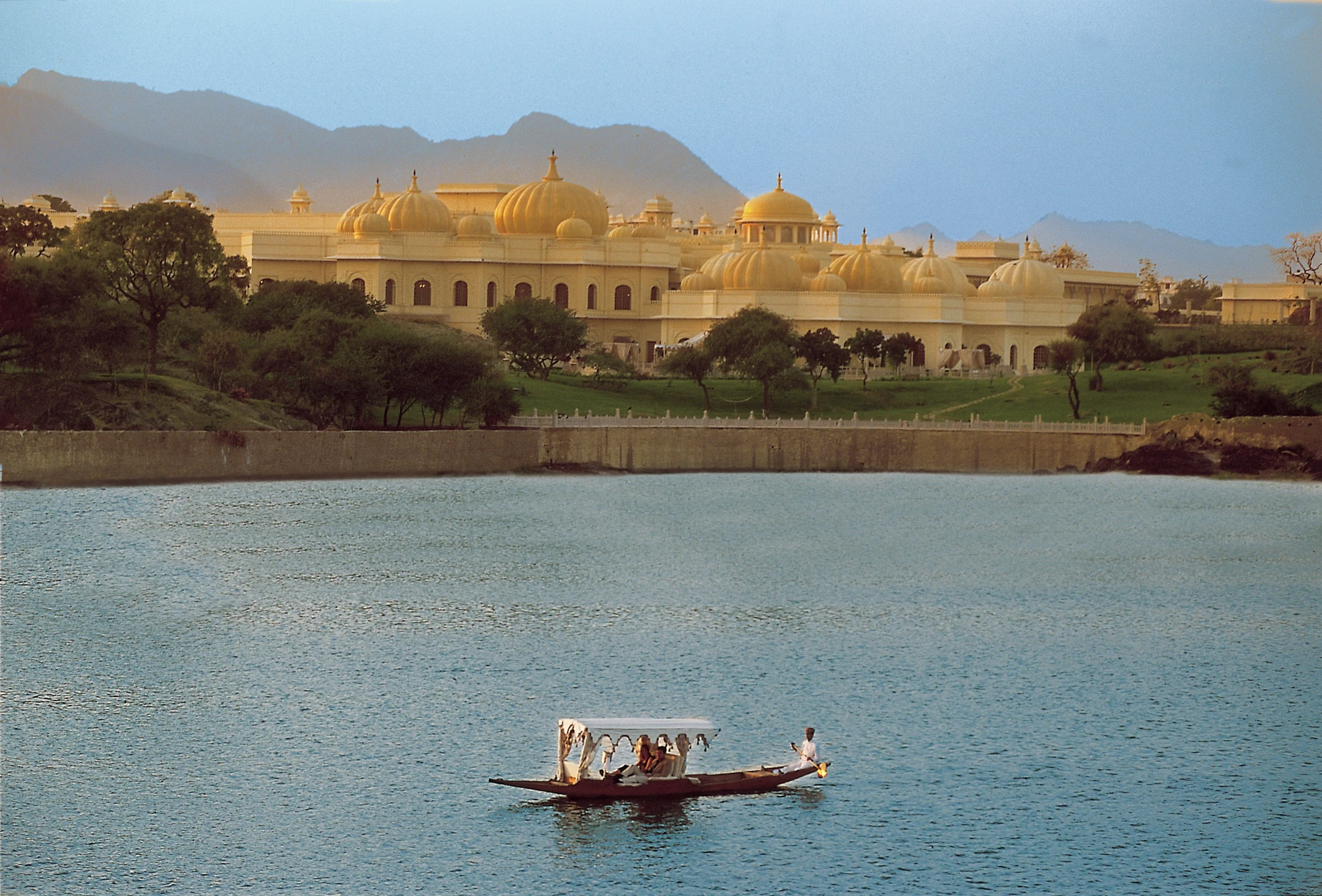 IN - The Oberoi Udaivilas - River and Hotel Exterior.webp